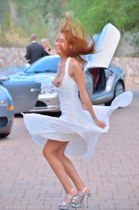 Cute redhead with humongous hard nipples flashes nude upskirt in the driveway