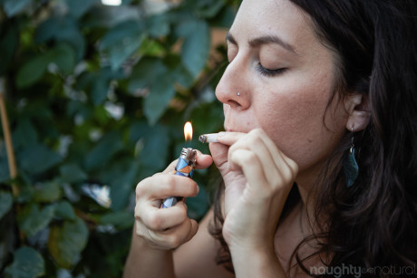 Amateur babe Nikki Silver smokes a spliff while posing undressed indoors and out