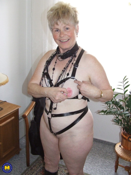 Mature BBW with short spiky hair takes off lingerie and fetish gear to go nude