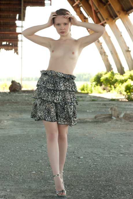 Russian teenie Virginia Sun strips nude outdoors & reveals her slim body