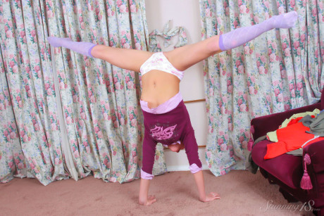 Young young looking skank girl broad Bella D does a handstand before getting undressed in knee socks