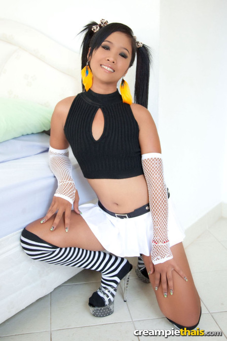 Pretty Thai teenie Thip lifts her skirt up and shows her bald cunt