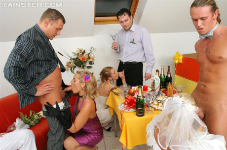 New bride dressed in her wedding dress plays water sport games at reception