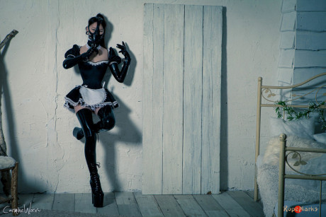 Korean model poses for a solo shoot in a dirty rubber maid outfit