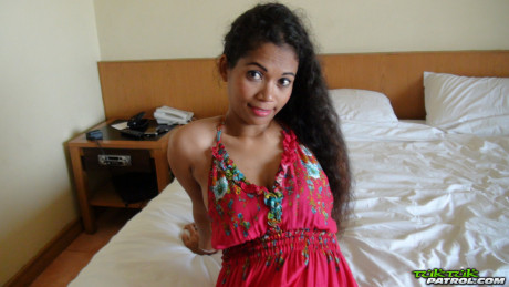Curly-haired Thai babe Nees shows her pretty boobies & her bald vagina