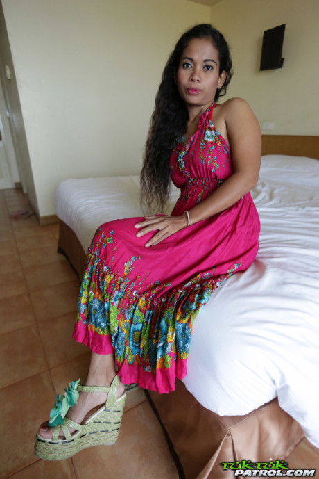 Curly-haired Thai babe Nees shows her pretty boobies & her bald vagina