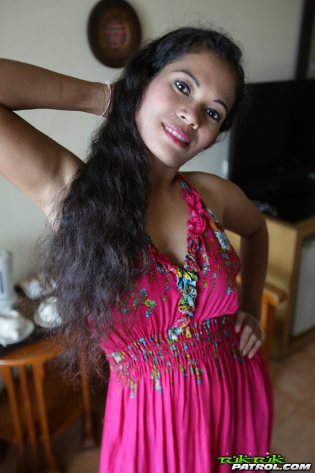 Curly-haired Thai babe Nees shows her pretty boobies & her bald vagina