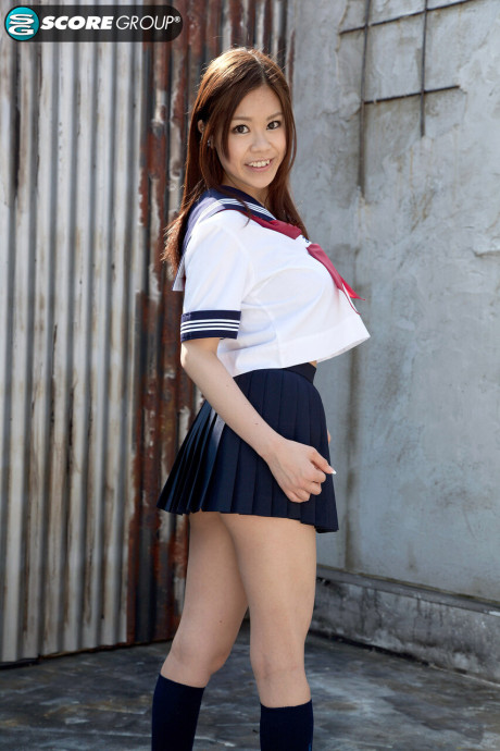 Chinese schoolgirl Ria Sakuragi shows off her humongous tits during a striptease