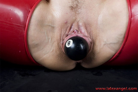 Brunette MILF sticks an eight ball into her anus while wearing latex attire