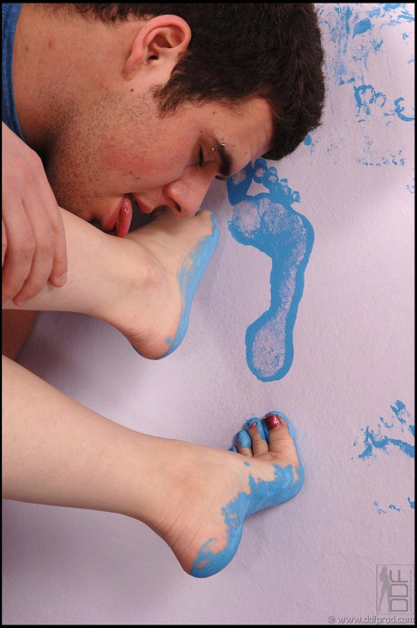 Redheaded nympho Ariel Piperfawn gives a sexy tasty footjob to her man