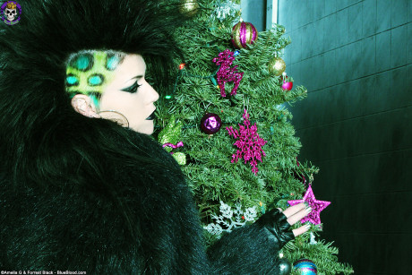 Goth skank girlfriend woman Malice shows her tattooed wares in front of Xmas tree