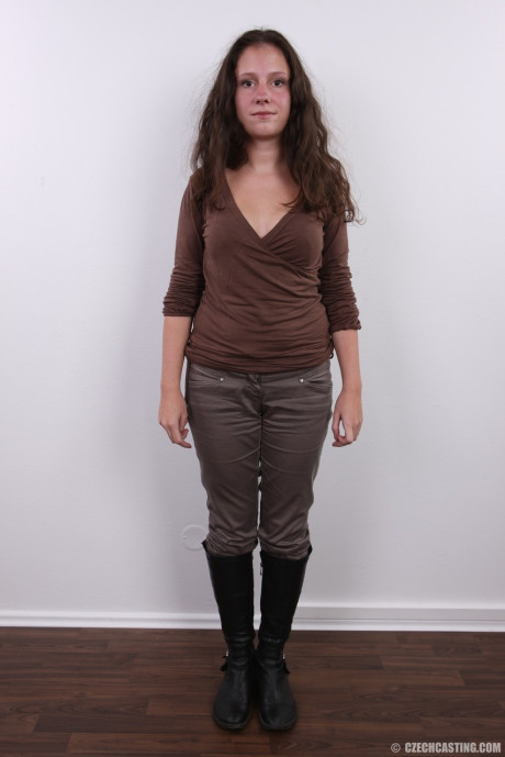 Brunette amateur Dominika poses clothed in boots and then totally naked