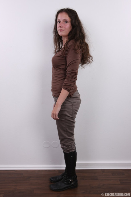 Brunette amateur Dominika poses clothed in boots and then totally naked