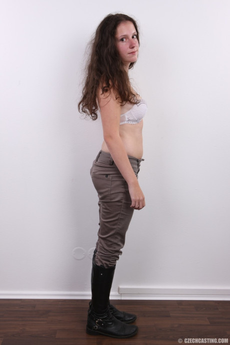 Brunette amateur Dominika poses clothed in boots and then totally naked