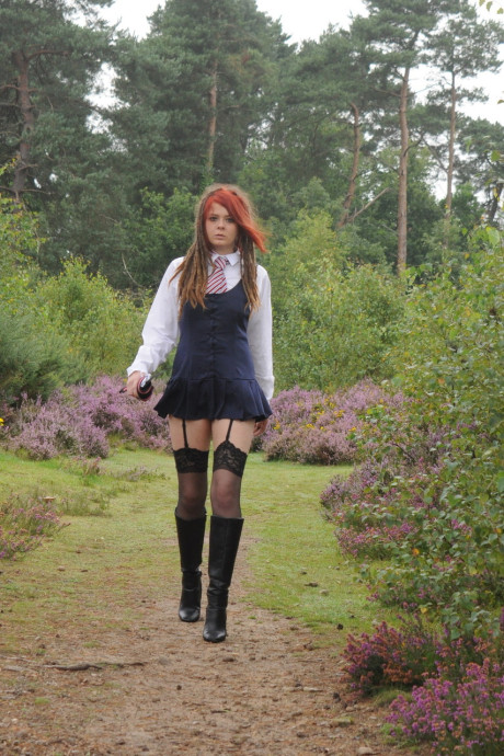 Tall schoolgirl shows off her hot legs in nylons and boots outdoors