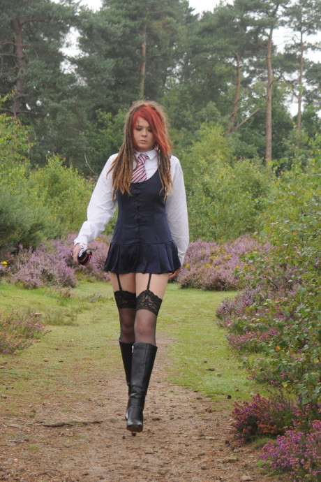 Tall schoolgirl shows off her hot legs in nylons and boots outdoors