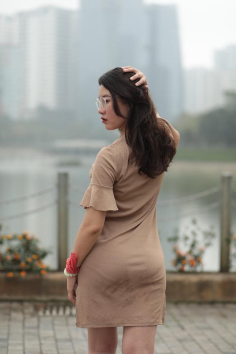 Thin oriental babe with eyeglasses posing in her tight skirt in public