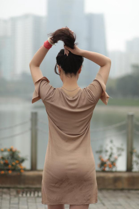Thin oriental babe with eyeglasses posing in her tight skirt in public