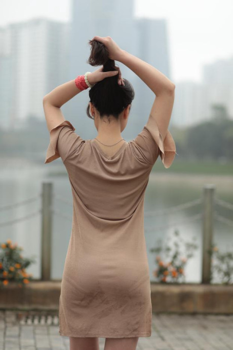 Thin oriental babe with eyeglasses posing in her tight skirt in public
