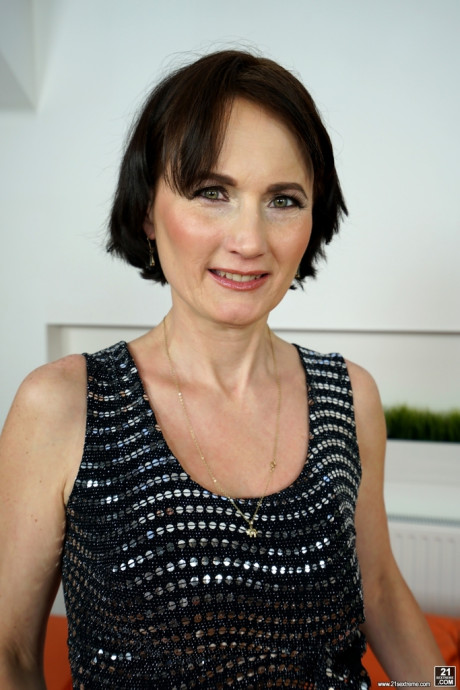 Short haired old lady Alice Sharp bares her saggy titties as she strips undressed