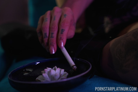 Inked pornstar Olivia black poses in enormous heels and negligee while smoking