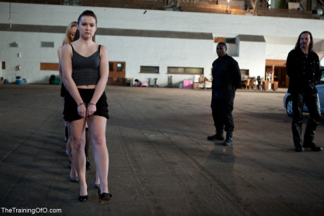 Lined up damsels in handcuffs getting stripped by their male BDSM handlers