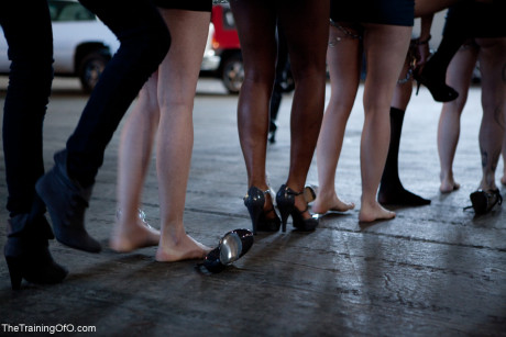 Lined up damsels in handcuffs getting stripped by their male BDSM handlers