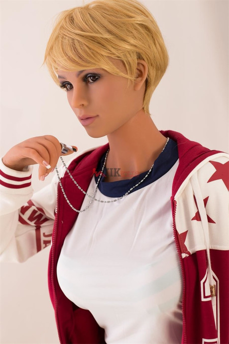 Blondy sex doll Mina touching her large tits and bald vagina in a varsity jacket