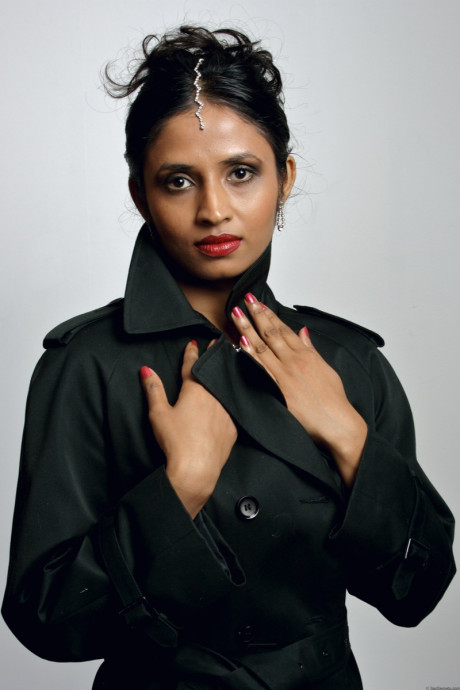 Gorgeous Indian female sheds an overcoat to model in underwear and stockings
