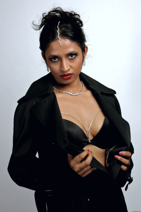 Gorgeous Indian female sheds an overcoat to model in underwear and stockings