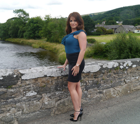 Non undressed model Penny poses outside to show off her super hot legs and ankles