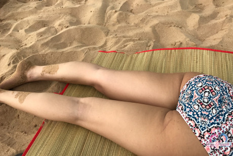 Amateur girl Liza Rowe poses in her pretty bikini on a sandy beach