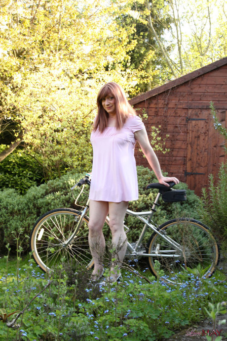 Redheaded trans broad pulls out her cock while riding a bicycle