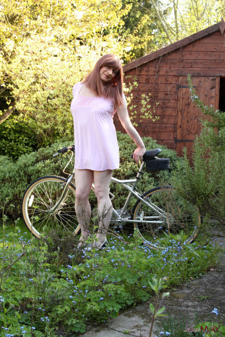 Redheaded trans broad pulls out her cock while riding a bicycle