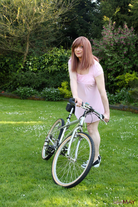 Redheaded trans broad pulls out her cock while riding a bicycle