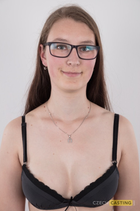 Nerdy young Katerina stands naked as can be other than her glasses in the naked