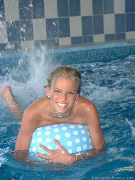 Pretty blondy young Lilu plays nude in the pool before posing with two studs