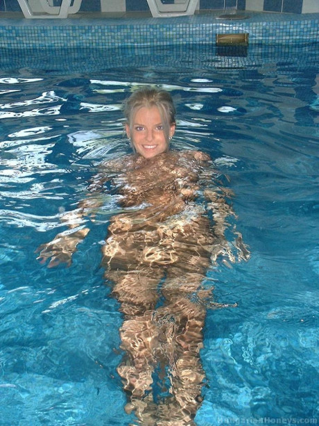 Pretty blondy young Lilu plays nude in the pool before posing with two studs