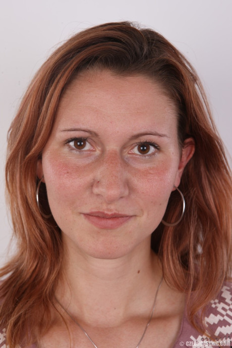 Ginger first timer holds her face firm while taking off all her clothes