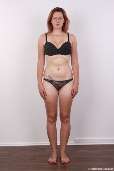 Ginger first timer holds her face firm while taking off all her clothes