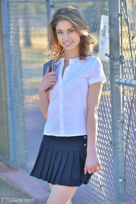 Thin teenie shows off her upskirt panties in her schoolgirl uniform on sidewalk