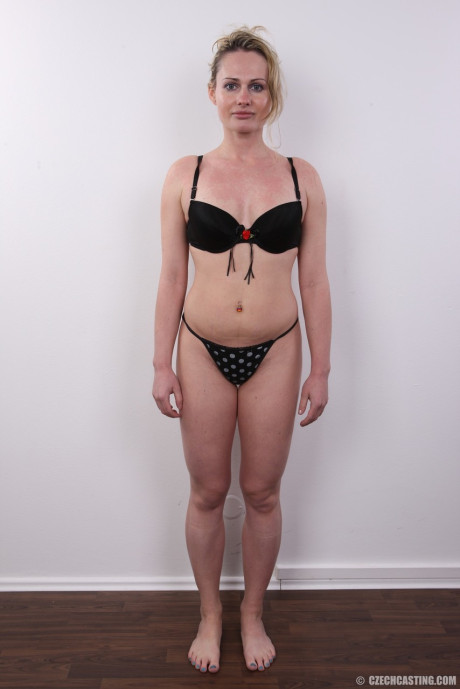 Slutty blond takes off her clothes an item at a time until she's standing nude