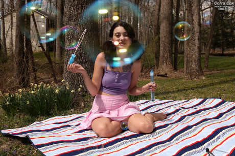 Fine brunette Corra Cox blows soap bubbles before masturbating with toys