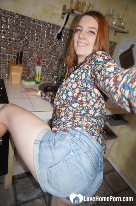 Amateur red hair shows off her round behind while taking undressed selfies