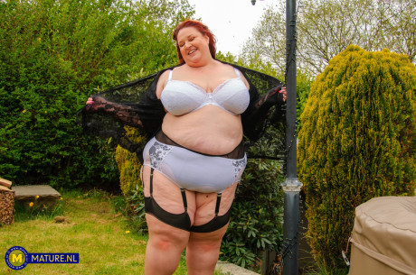 Morbidly obese cougar red hair dildos her twat in a garter belt and stockings
