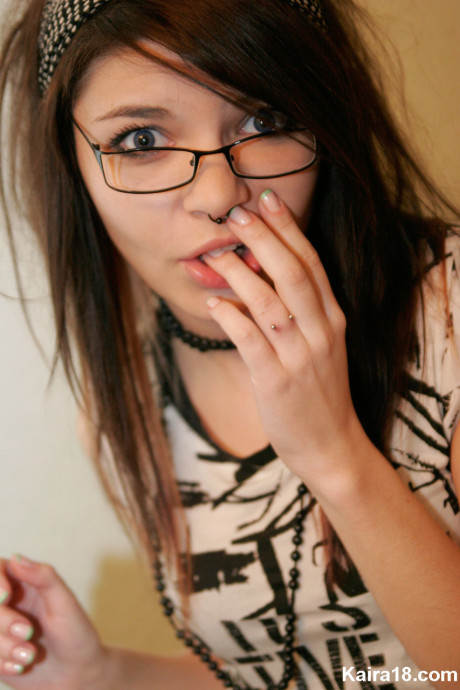 Young young brunette Kaira 18 takes off her glasses while modelling non undressed