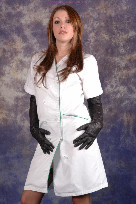 Hot nurse Sophie exposes her stocking tops in long ebony leather gloves