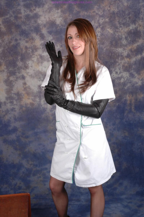 Hot nurse Sophie exposes her stocking tops in long ebony leather gloves