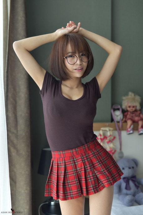 Stunning attractive oriental young flaunts her hot booty wearing a miniskirt and panties