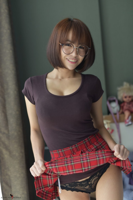 Stunning attractive oriental young flaunts her hot booty wearing a miniskirt and panties